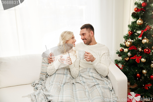 Image of happy couple at home with christmas tree