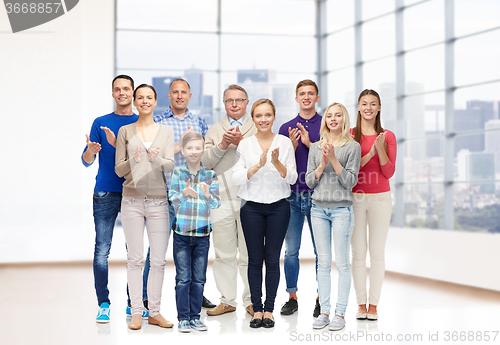 Image of group of smiling people applauding