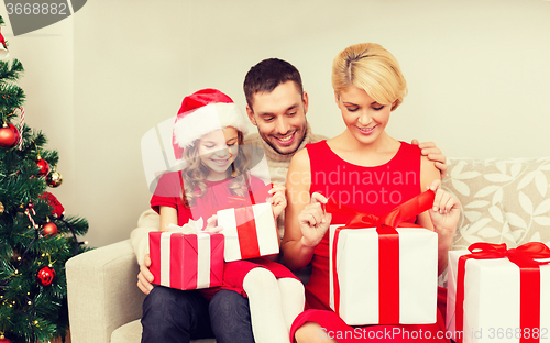 Image of happy family opening gift boxes