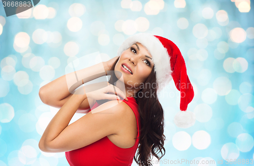Image of beautiful sexy woman in santa hat and red dress