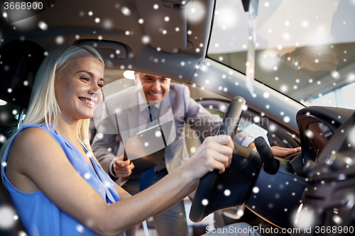 Image of happy woman with car dealer in auto show or salon