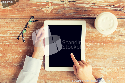 Image of close up of female hands with tablet pc and coffee