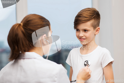 Image of doctor with stethoscope listening to happy child