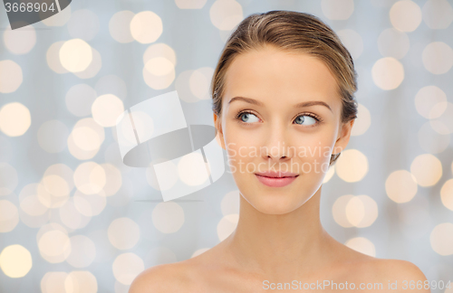 Image of smiling young woman face and shoulders