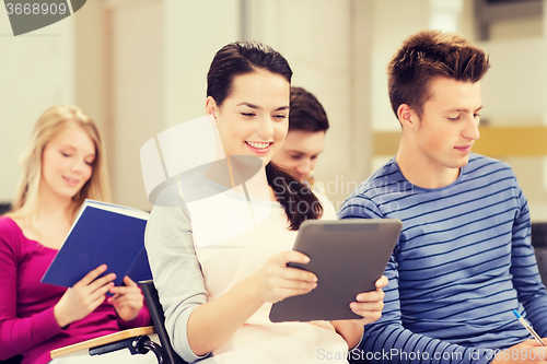 Image of group of smiling students with tablet pc