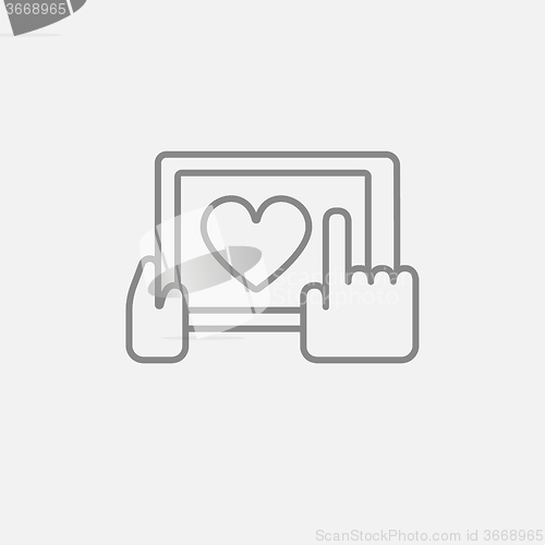 Image of Hands holding tablet with heart sign line icon.