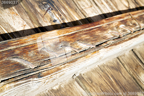 Image of metal  in the brown   red wood door and  