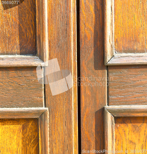 Image of  in mozzate  a  door curch  closed metal wood italy  lombardy   