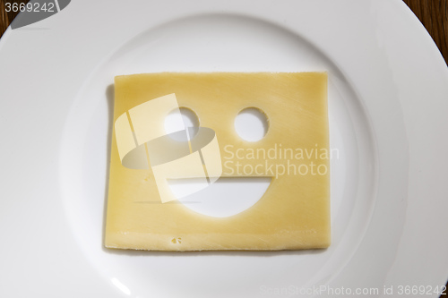 Image of Cheese with smiling face on a table