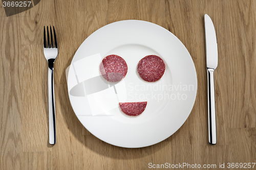 Image of \"Smiling\" salami slices on plate