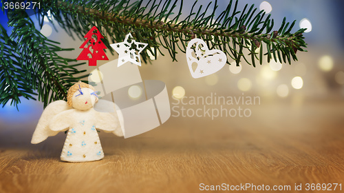 Image of branch, felt angel and bokeh lights