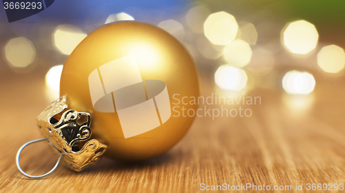 Image of golden bauble with bokeh lights