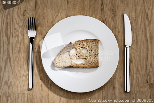 Image of bread with smiling face on a white plate