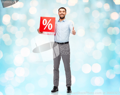 Image of smiling man with red shopping bag