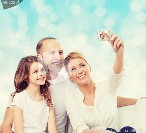 Image of happy family with camera at home