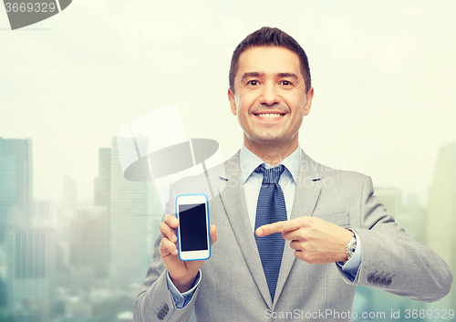 Image of happy businessman showing smartphone screen