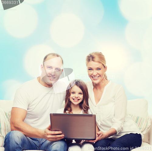 Image of smiling family with laptop