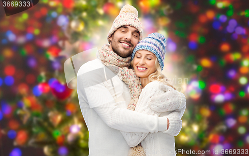 Image of smiling couple in winter clothes hugging