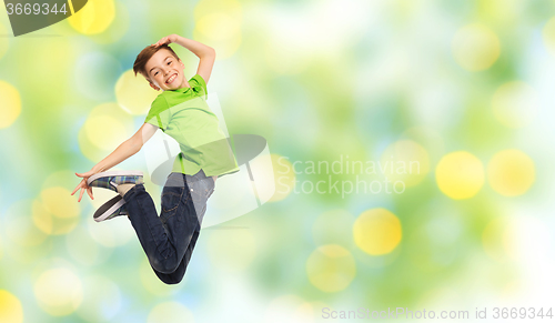 Image of smiling boy jumping in air