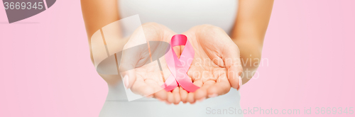 Image of hands holding pink breast cancer awareness ribbon