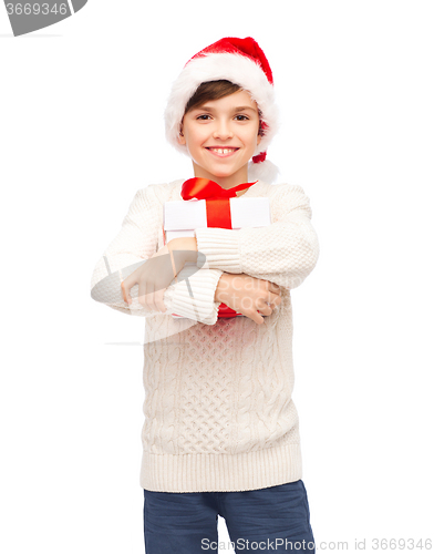 Image of smiling happy boy in santa hat with gift box