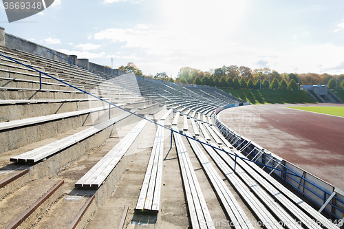 Image of stands with rows of benches on stadium