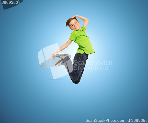 Image of smiling boy jumping in air