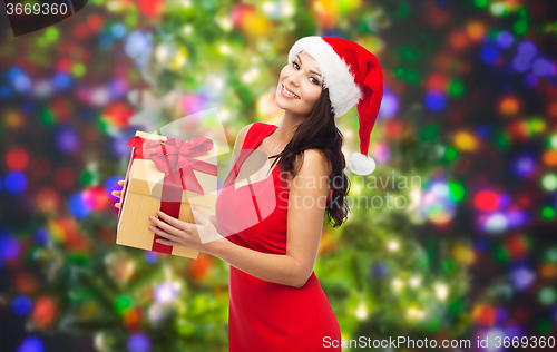 Image of beautiful sexy woman in santa hat with gift box