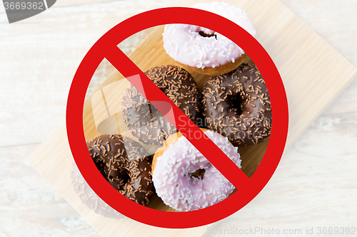 Image of close up of glazed donuts pile behind no symbol