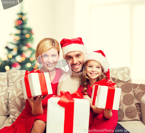 Image of smiling family giving many gift boxes