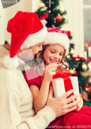 Image of smiling father and daughter opening gift box