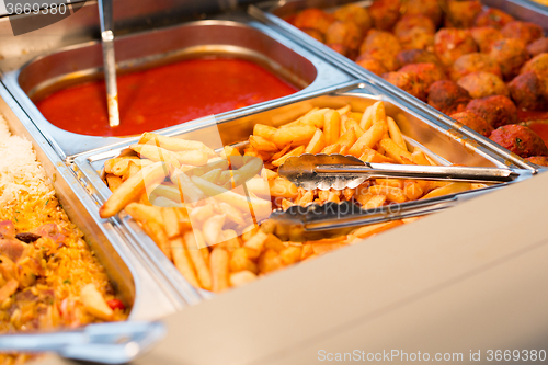 Image of close up french fries of and other dishes on tray