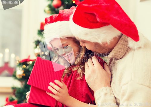 Image of smiling father and daughter opening gift box