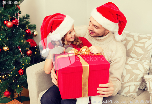 Image of smiling father and daughter opening gift box