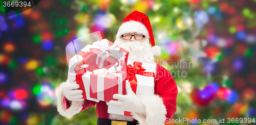 Image of man in costume of santa claus with gift boxes