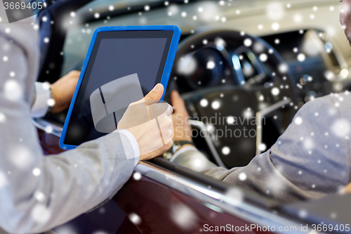 Image of close up of men with tablet pc and cabrio car