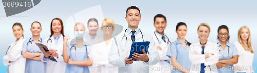 Image of group of doctors with tablet pc and clipboard