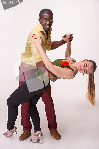 Image of Young couple dances Caribbean Salsa, studio shot