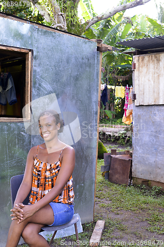 Image of editorial woman in front of new zinc house Nicaragua