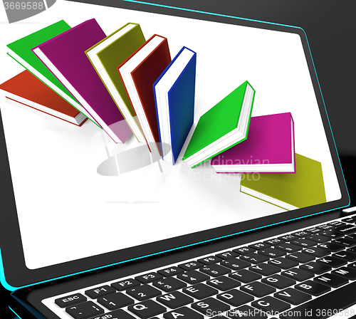 Image of Books On Laptop Shows Research