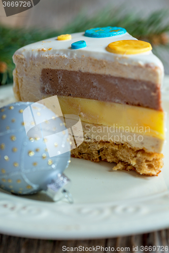 Image of Piece of cake with spicy mousse and Christmas ball.