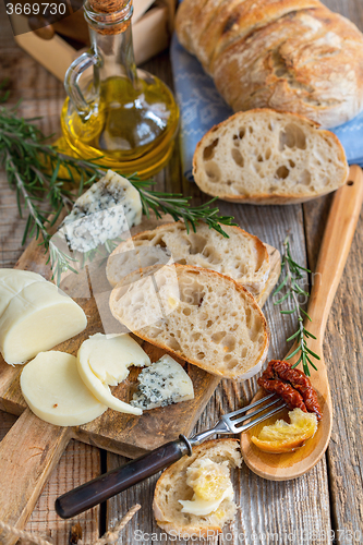 Image of Table with rustic snacks and homemade bread.