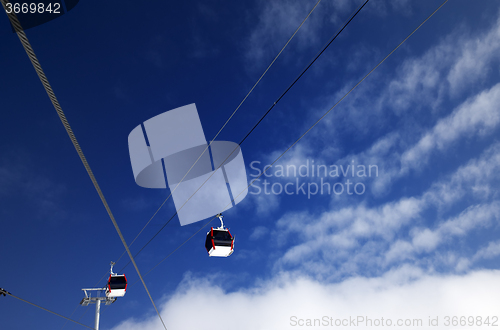 Image of Gondola lifts at ski resort and blue sky with clouds in nice day