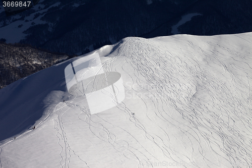 Image of Top view on off piste slope with snowboarders and skiers at even