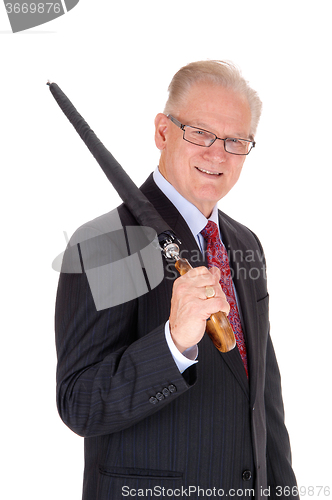 Image of Senior man with umbrella over shoulder.