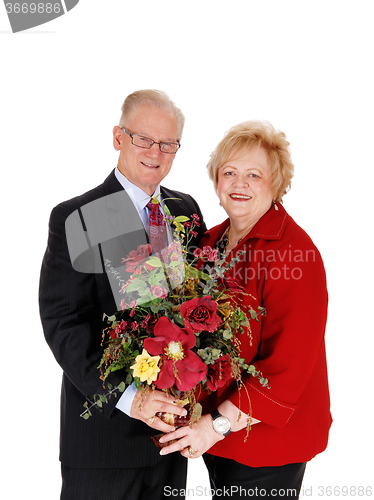 Image of Closeup of senior couple with flowers.