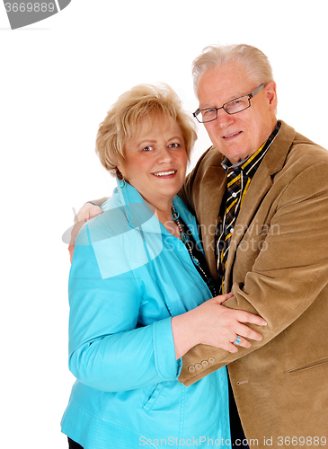 Image of Senior couple standing and hugging.