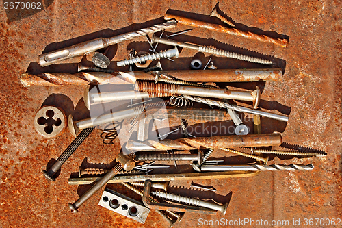 Image of Metal objects on the rusty iron sheet