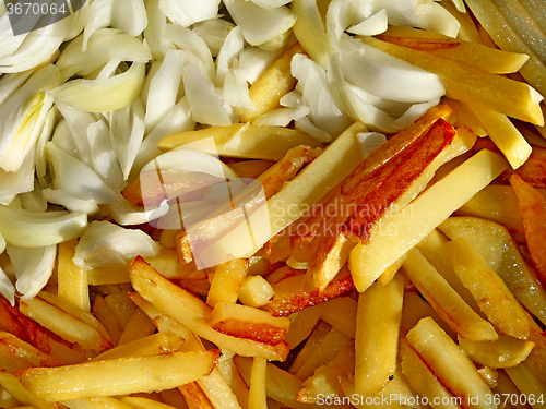 Image of Fried potato chips and cutting onions