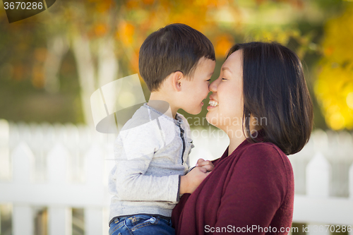 Image of Chinese Mom Having Fun and Holding Her Mixed Race Boy